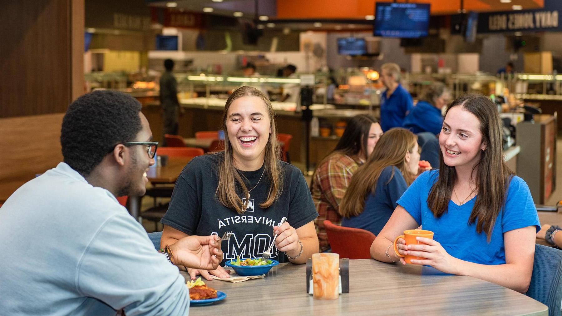 Students having fun with friends while eating at the Crow's Nest